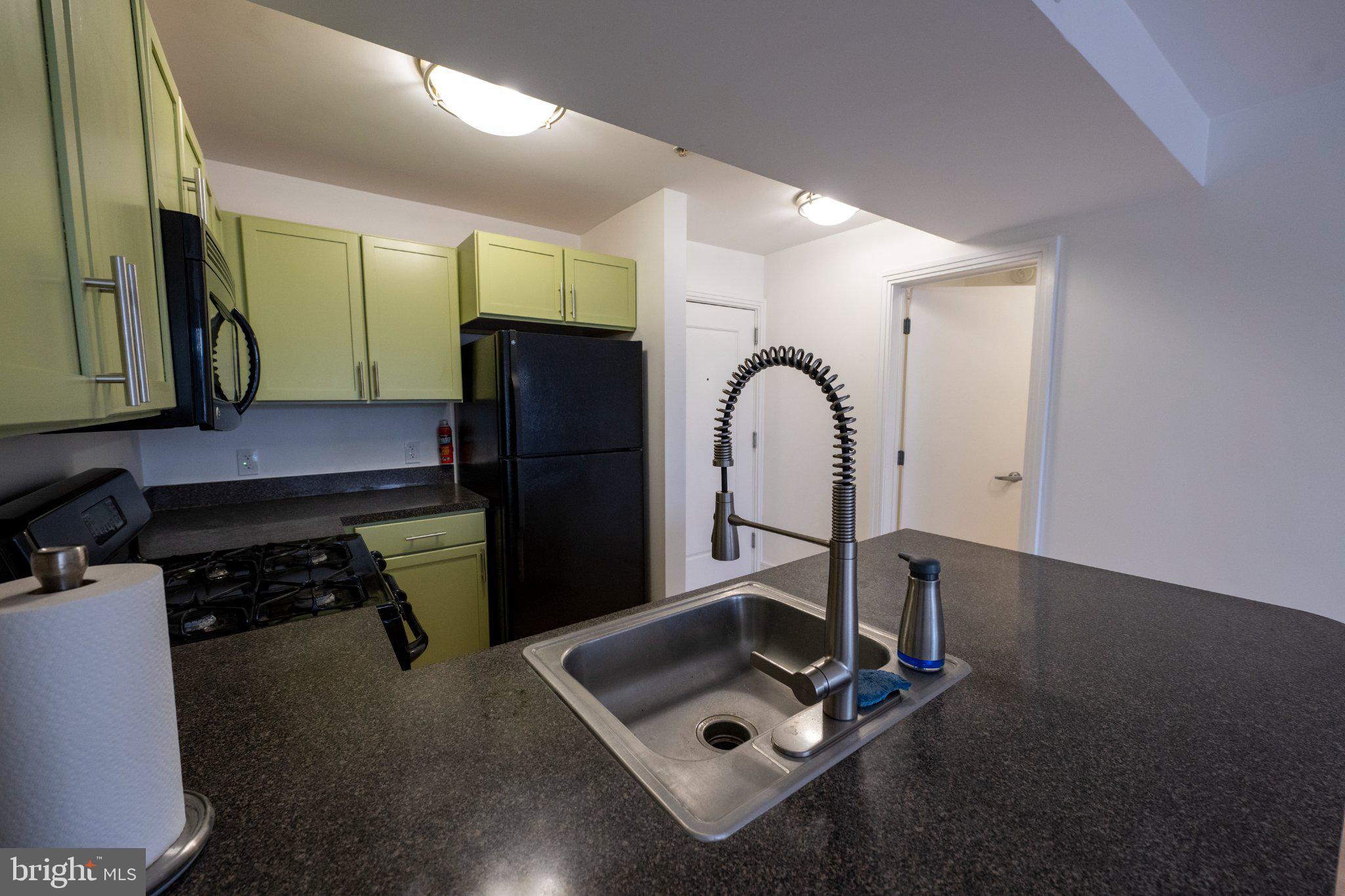 800 4th Street Southwest, Unit N107 Washington, DC 20024 - Photo 17 of 52 Modern kitchen with vibrant cabinetry.