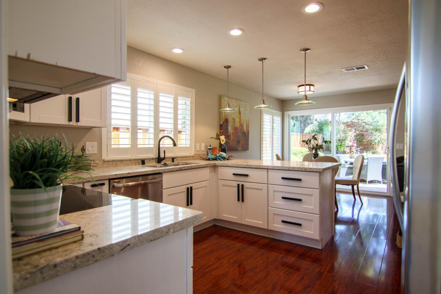 4240 Briarglen Drive San Jose, CA 95118 - Photo 12 of 42 a large kitchen with kitchen island a stove a sink a dining table and chairs