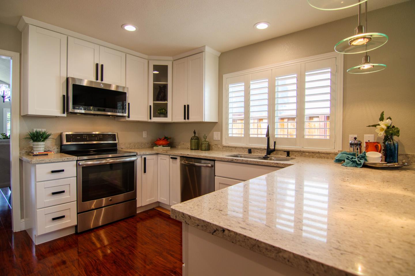 4240 Briarglen Drive San Jose, CA 95118 - Photo 13 of 42 a kitchen with stainless steel appliances kitchen island granite countertop a stove a sink and a microwave