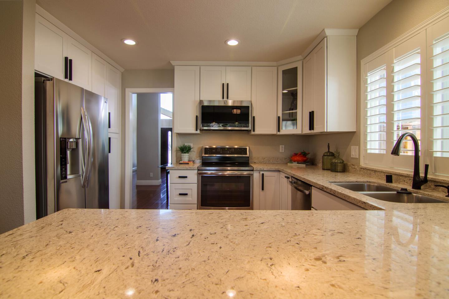 4240 Briarglen Drive San Jose, CA 95118 - Photo 14 of 42 a kitchen with granite countertop a refrigerator and a stove top oven