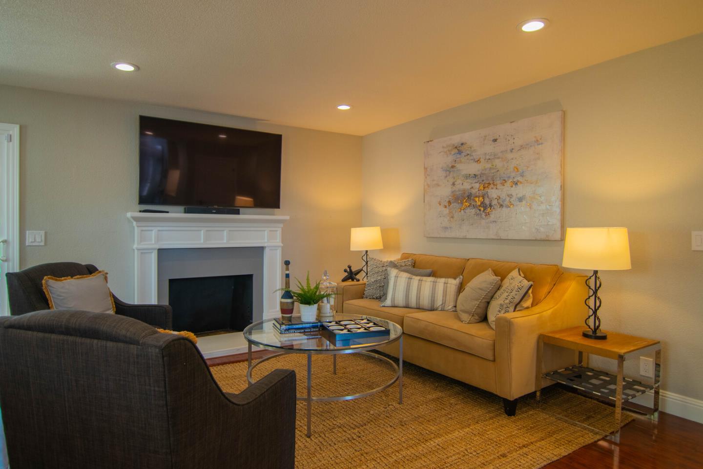 4240 Briarglen Drive San Jose, CA 95118 - Photo 18 of 42 a living room with furniture a flat screen tv and a fireplace
