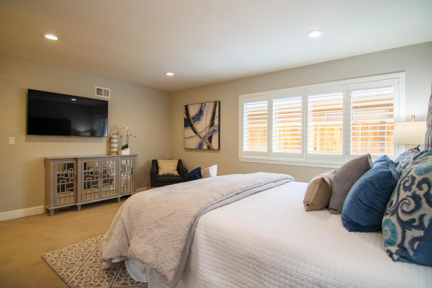 4240 Briarglen Drive San Jose, CA 95118 - Photo 23 of 42 a bedroom with a large bed and a flat screen tv