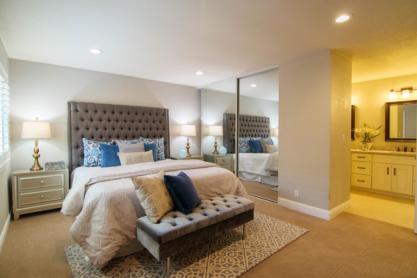 4240 Briarglen Drive San Jose, CA 95118 - Photo 24 of 42 a spacious bedroom with a bed a couch and chandelier