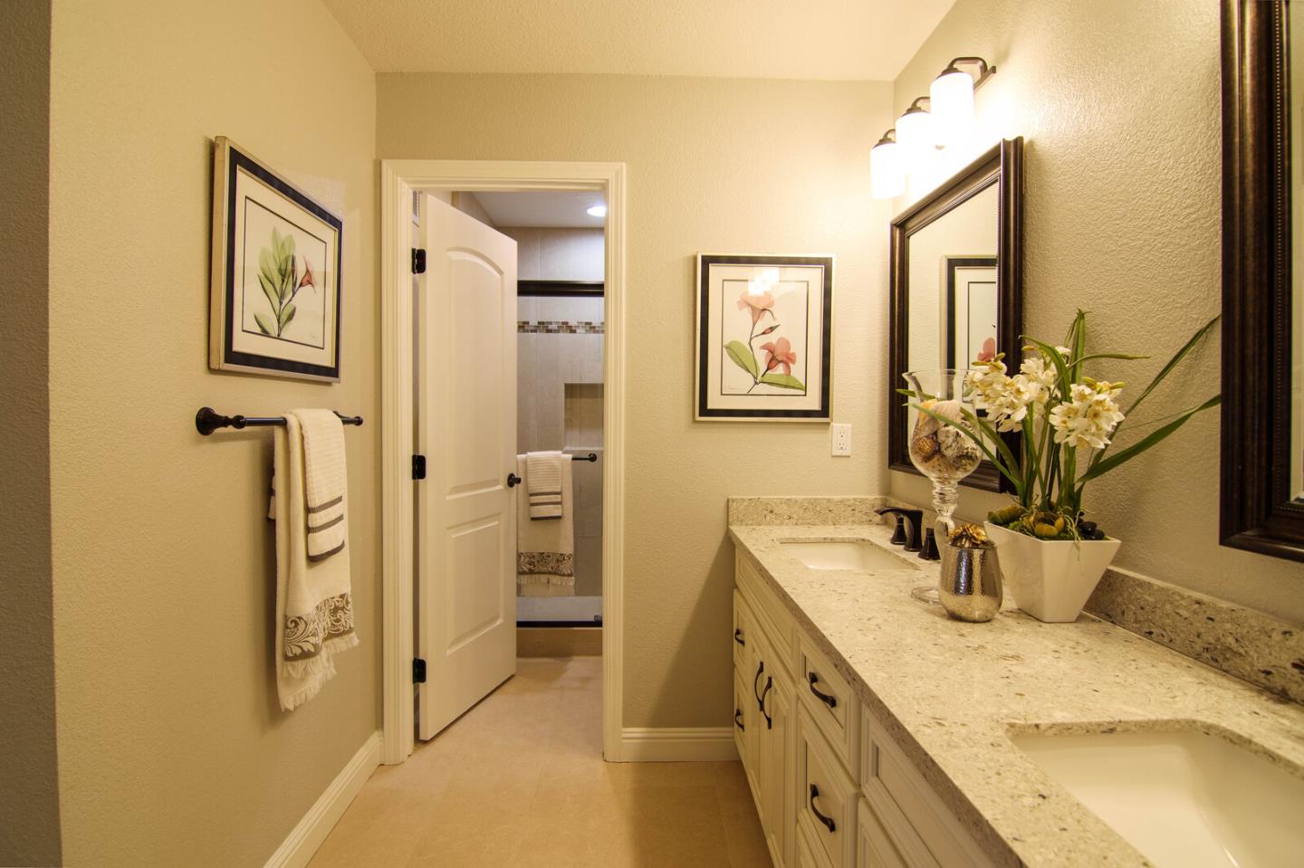 4240 Briarglen Drive San Jose, CA 95118 - Photo 27 of 42 a bathroom with a granite countertop sink a mirror and shower