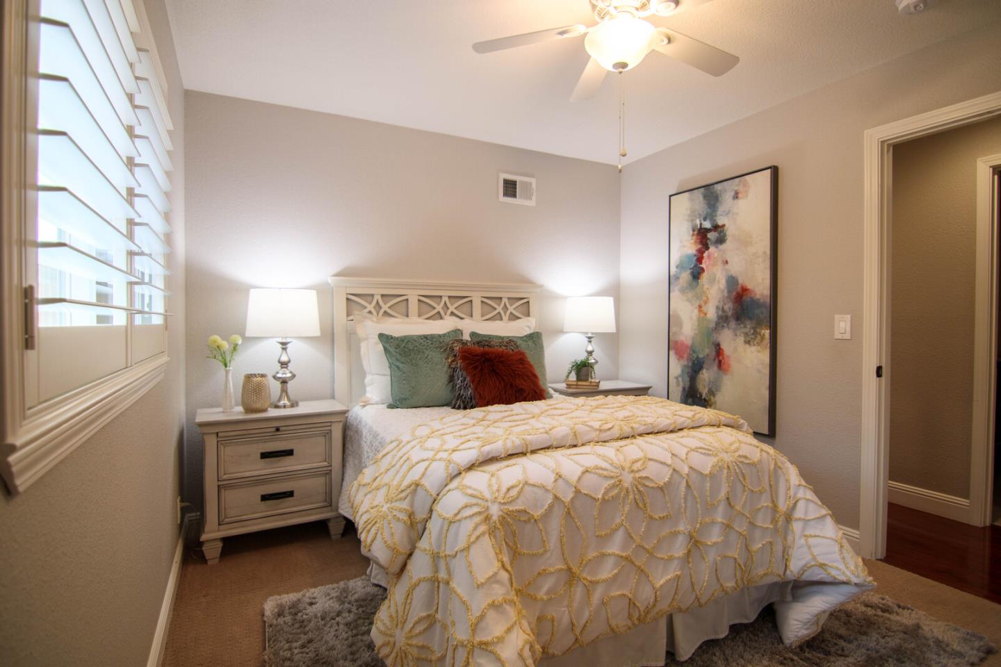 4240 Briarglen Drive San Jose, CA 95118 - Photo 30 of 42 a bedroom with a bed and a chandelier