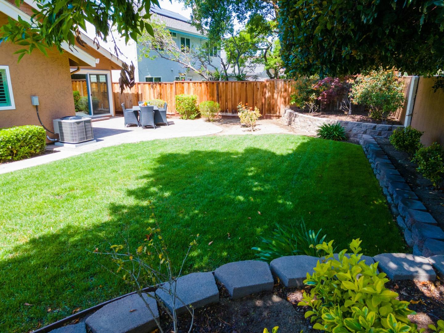 4240 Briarglen Drive San Jose, CA 95118 - Photo 40 of 42 a view of a backyard with table and chairs potted plants and a large tree