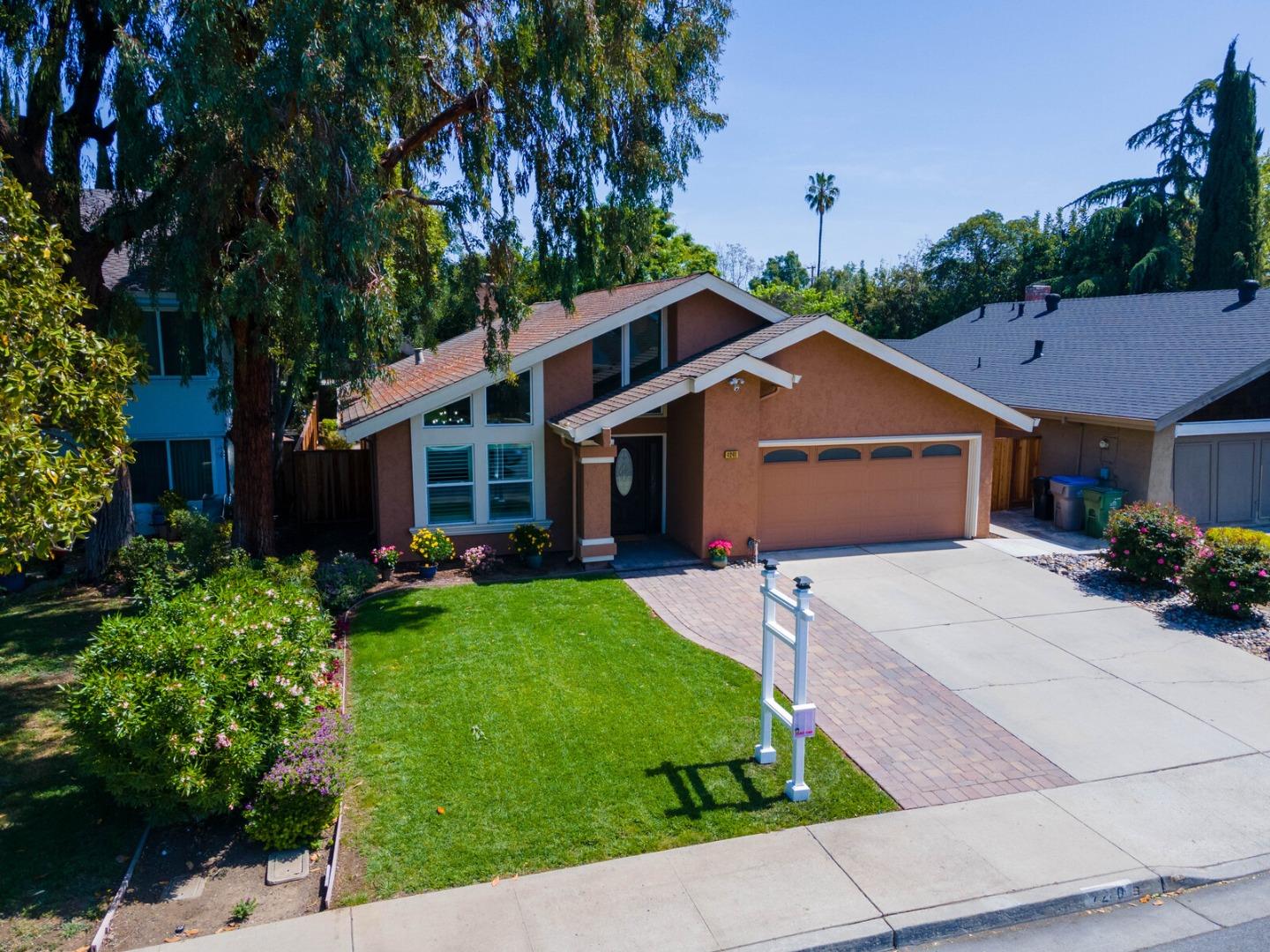 4240 Briarglen Drive San Jose, CA 95118 - Photo 42 of 42 a front view of a house with a yard and garage