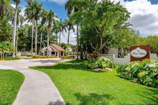 a view of a garden with palm trees