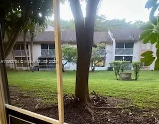 a view of a house with backyard sitting area and garden