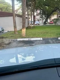 a view of outdoor space with garden and trees