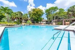 a view of a swimming pool with an outdoor seating