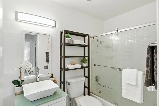 a bathroom with a toilet a sink and shower