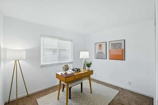 a workspace with furniture and window