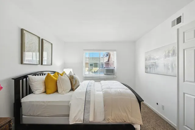 a bedroom with a bed and couch