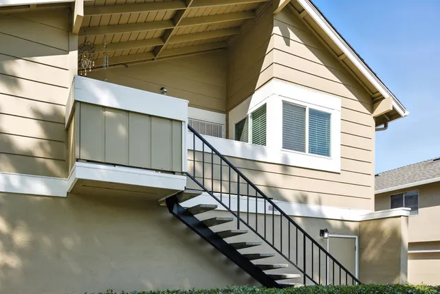 a view of a room with wooden floor and a fireplace