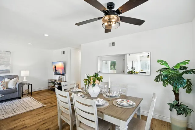 a view of a dining room with furniture and wooden floor