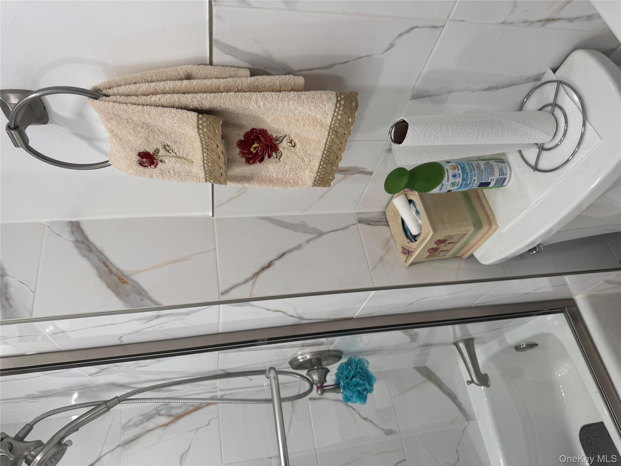 Undisclosed Address Hempstead, NY 11550 - Photo 5 of 5 Bathroom with bath / shower combo with glass door and tile walls