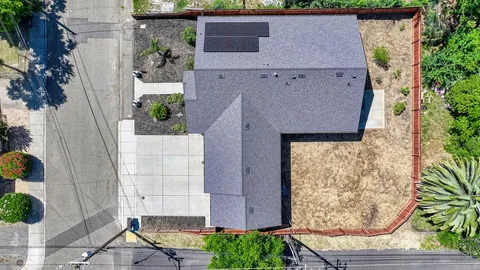 an aerial view of a house with a yard and potted plants