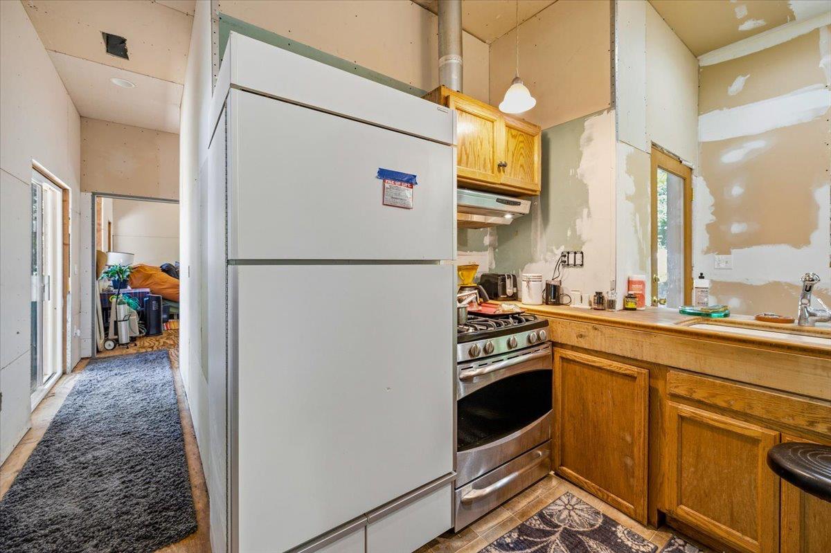 19643 Sages Road Nevada City, CA 95959 - Photo 10 of 39 a kitchen with a refrigerator a stove and a sink