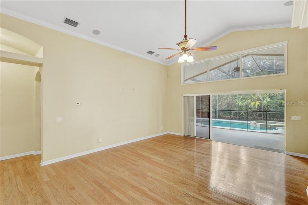 15129 Shearcrest Drive Lithia, FL 33547 - Photo 13 of 48 a view of empty room with wooden floor and fan