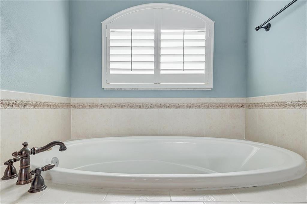 15129 Shearcrest Drive Lithia, FL 33547 - Photo 29 of 48 a bathroom with a bathtub and a window