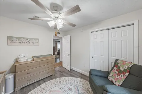 a bedroom with a bed and ceiling fan