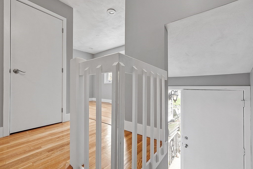 31 Blithewood Avenue, Unit 705 Worcester, MA 01604 - Photo 6 of 31 a view of a hallway with wooden floor and staircase