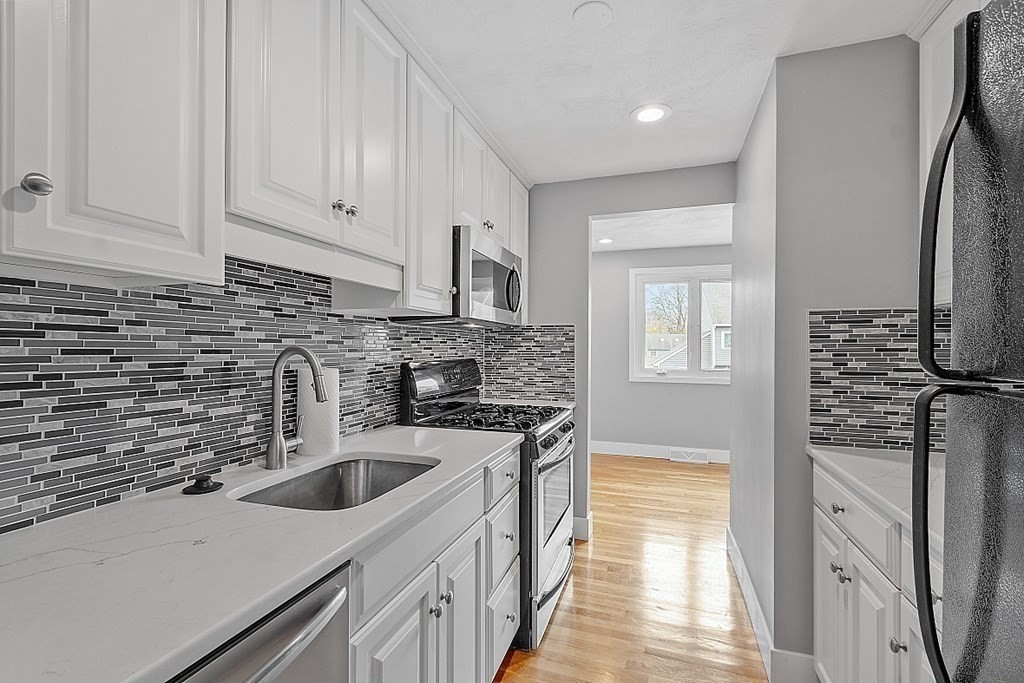 31 Blithewood Avenue, Unit 705 Worcester, MA 01604 - Photo 9 of 31 a kitchen with stainless steel appliances granite countertop a sink stove and refrigerator