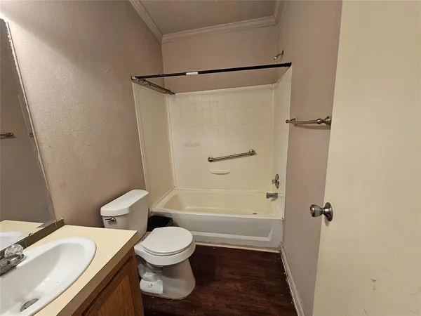 a white toilet sitting next to a bathroom sink