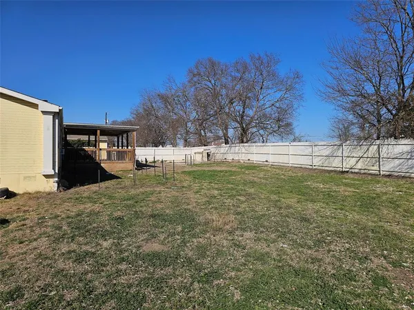 a view of a backyard with large trees