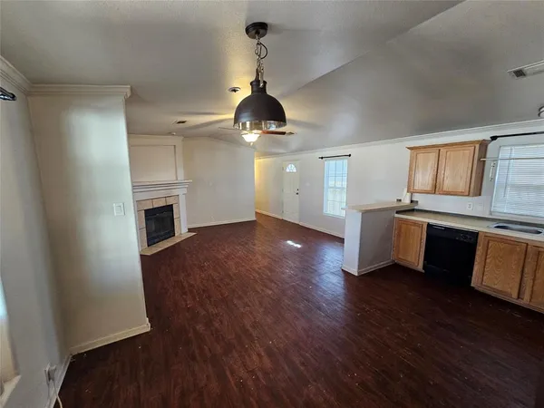 a room with wooden floors and fireplace