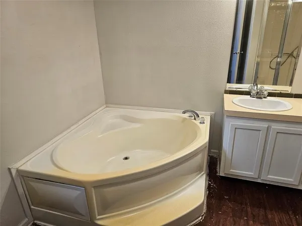 a bathroom with a bathtub and a sink