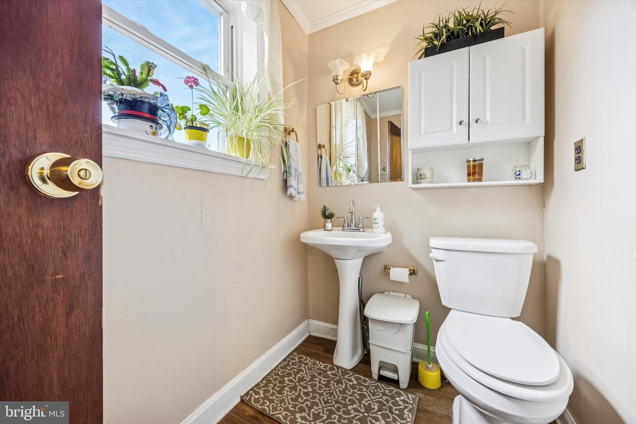 1601 Burmont Road Drexel Hill, PA 19026 - Photo 13 of 22 a bathroom with a toilet a sink and a mirror