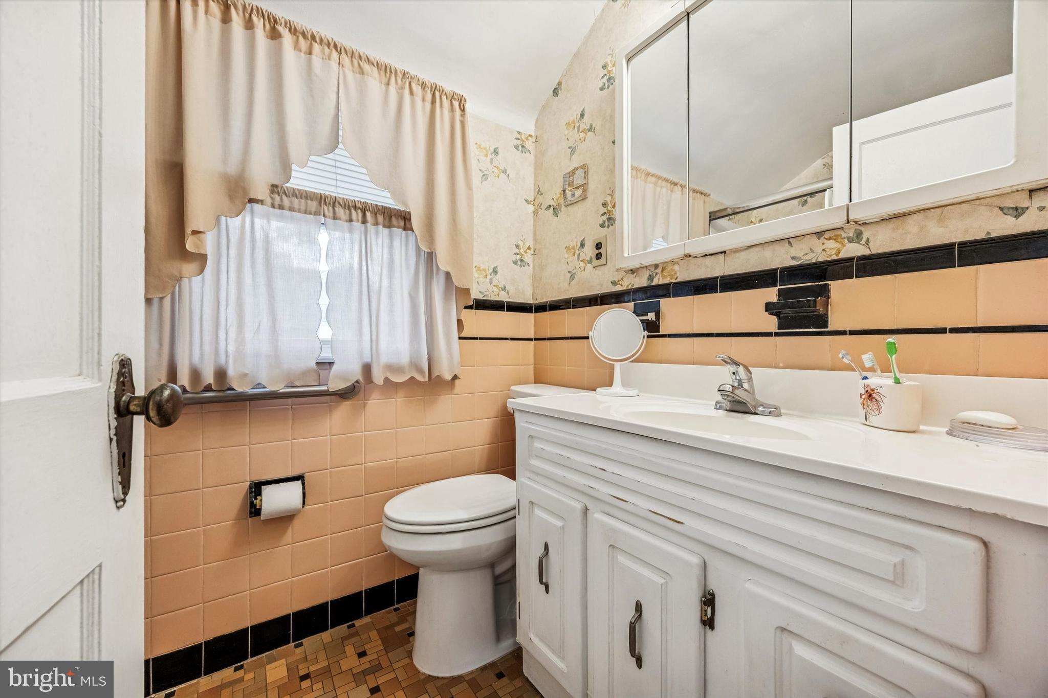 1601 Burmont Road Drexel Hill, PA 19026 - Photo 16 of 22 a bathroom with a sink a toilet and a mirror