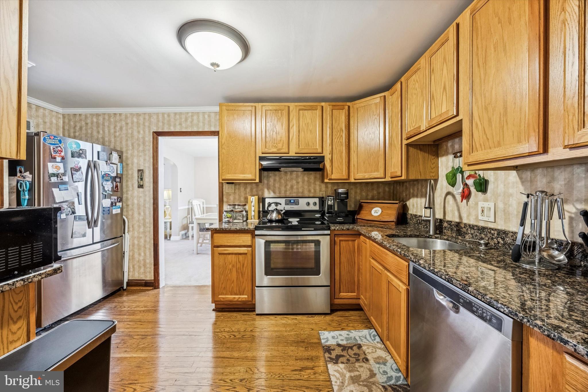 1601 Burmont Road Drexel Hill, PA 19026 - Photo 7 of 22 a kitchen with stainless steel appliances granite countertop a stove top oven a sink and a refrigerator