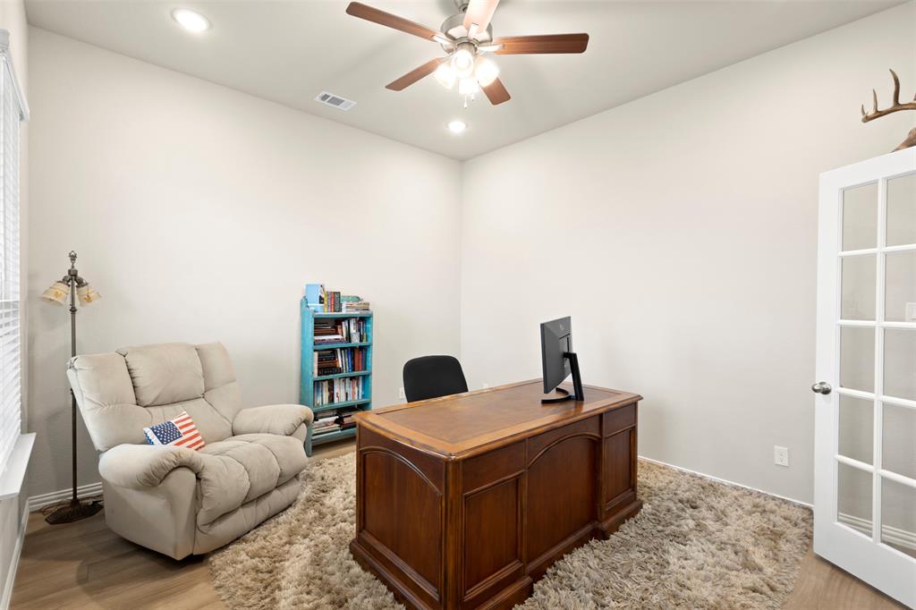 107 Yampa Court Rhome, TX 76078 - Photo 7 of 30 Interior room featuring a ceiling fan with integrated lighting, recessed lighting, wood-finish flooring, and a French door with clear glass panels