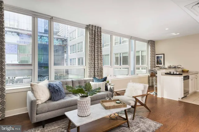 a living room with furniture and a large window