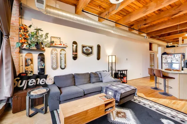 a living room with furniture and a black umbrella