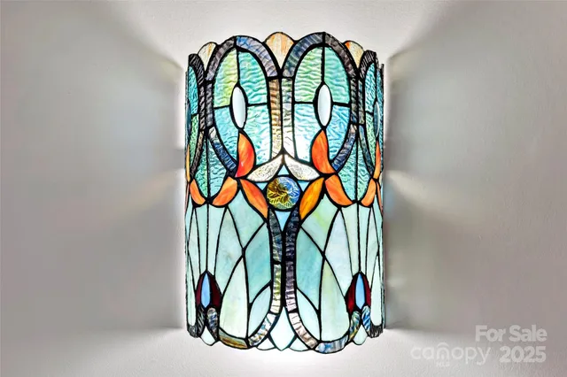 a view of a room with wooden floor and ceiling fan