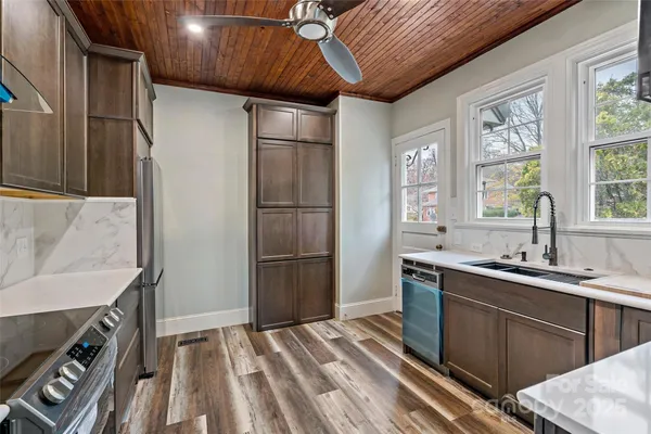 a close view of a sink a counter and appliances in a kitchen