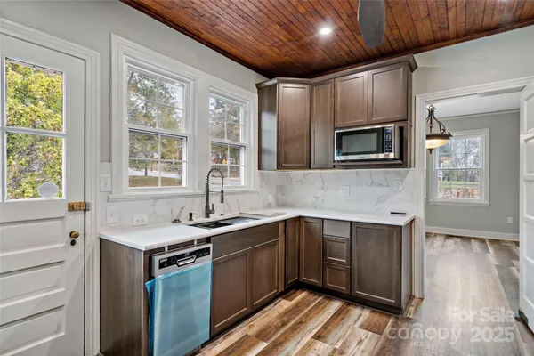 a kitchen with granite countertop stainless steel appliances and wooden cabinets