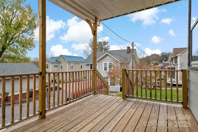 a view of a room with wooden floor and windows