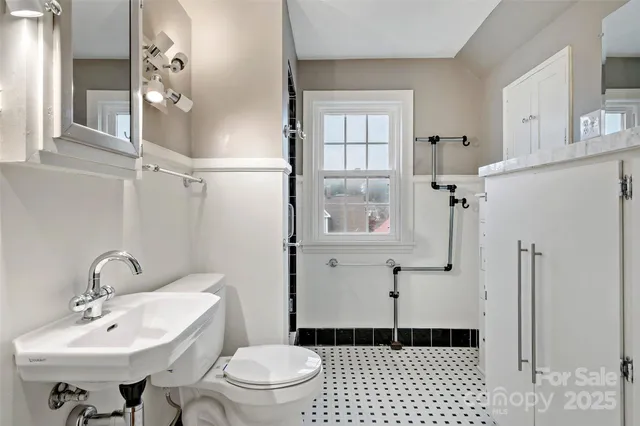 an empty room with wooden floor and ceiling fan