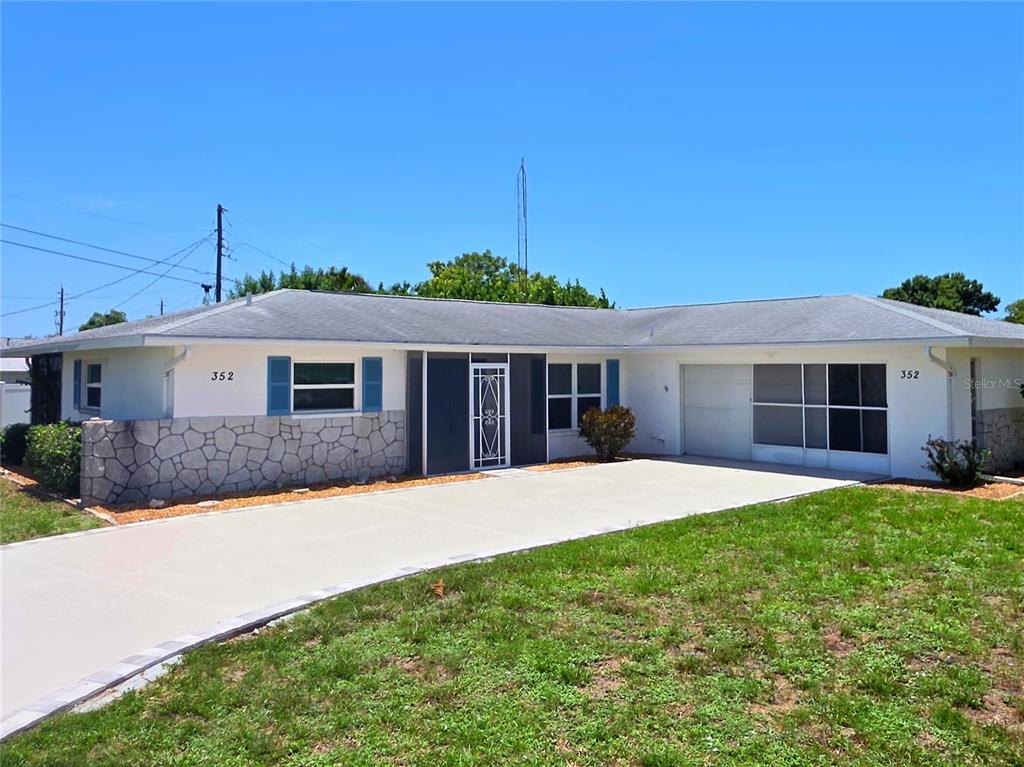 352 Pine Tree Road Venice, FL 34293 - Photo 2 of 25 a front view of a house with a garden and yard