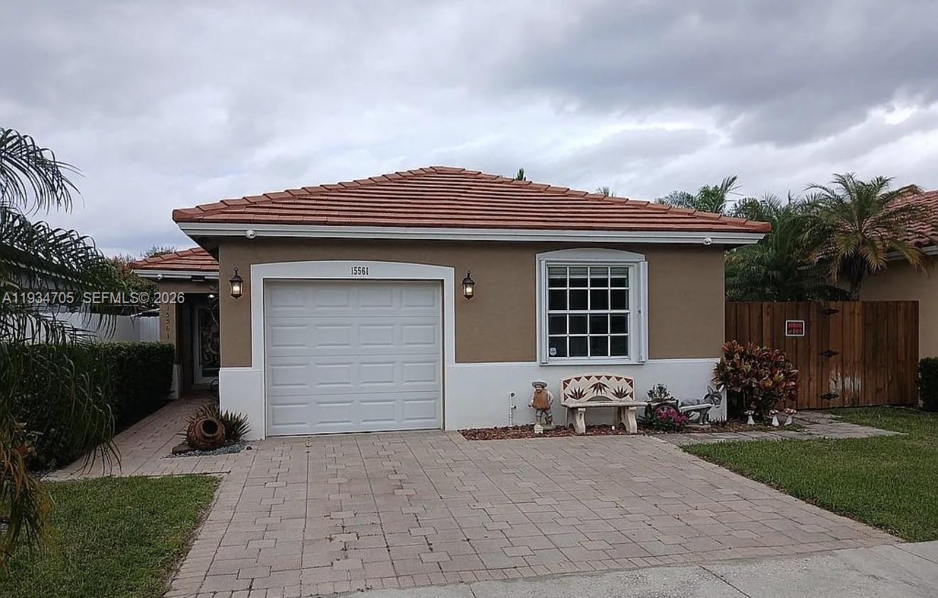 15561 Southwest 144th Terrace Miami, FL 33196 - Photo 1 of 10 a front view of a house with garden