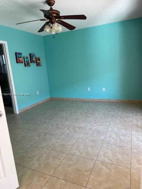 15561 Southwest 144th Terrace Miami, FL 33196 - Photo 5 of 10 a view of a room with a projector and fan