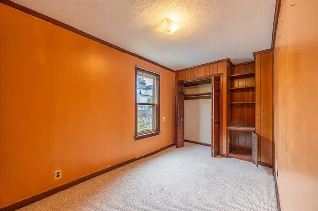 a view of an empty room with a closet