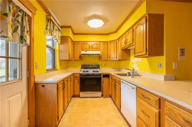 a kitchen with stainless steel appliances granite countertop a sink and a stove