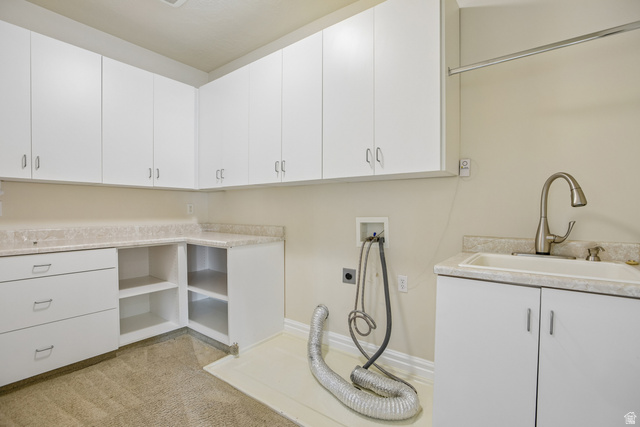 220 East Ridge Road Orem, UT 84057 - Photo 32 of 52 Extensive white cabinetry, integrated sink with gooseneck faucet, light-toned countertop, and open shelving