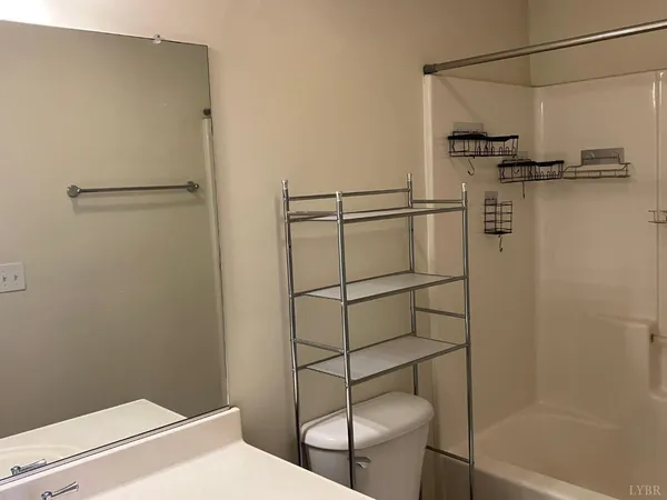 a bathroom with a shower and toilet